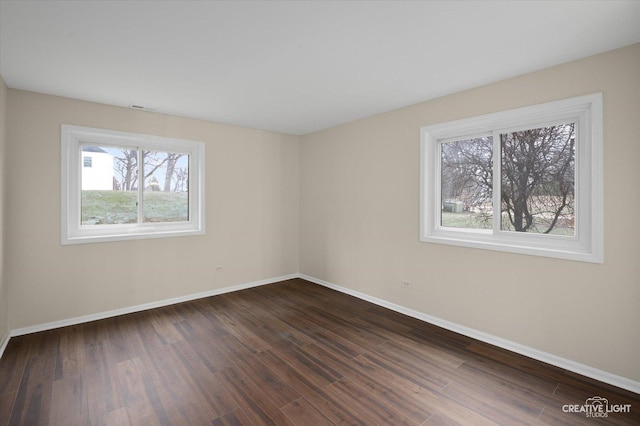 spare room featuring dark wood-type flooring