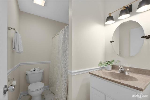 bathroom featuring vanity, tile patterned flooring, and toilet