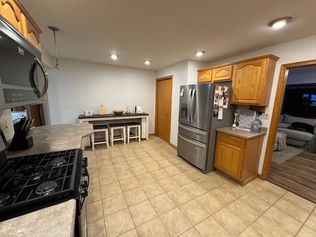 kitchen featuring light tile patterned flooring and appliances with stainless steel finishes