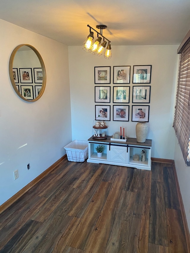 interior space featuring dark hardwood / wood-style floors and a notable chandelier