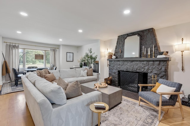 living room featuring a stone fireplace