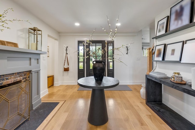 entrance foyer with a fireplace and light hardwood / wood-style floors