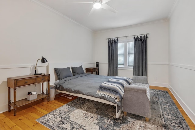 bedroom with crown molding, hardwood / wood-style flooring, and ceiling fan