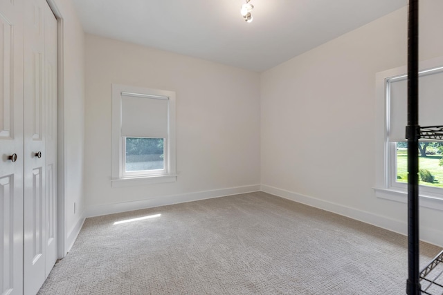 empty room featuring light carpet