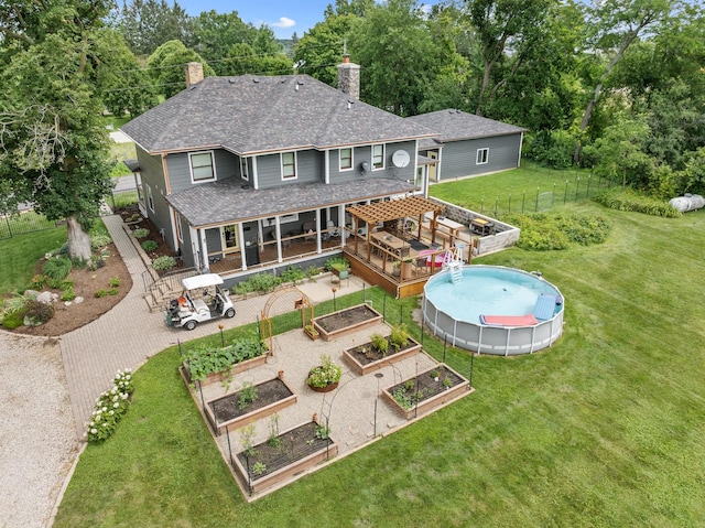 back of house with a yard and a pergola