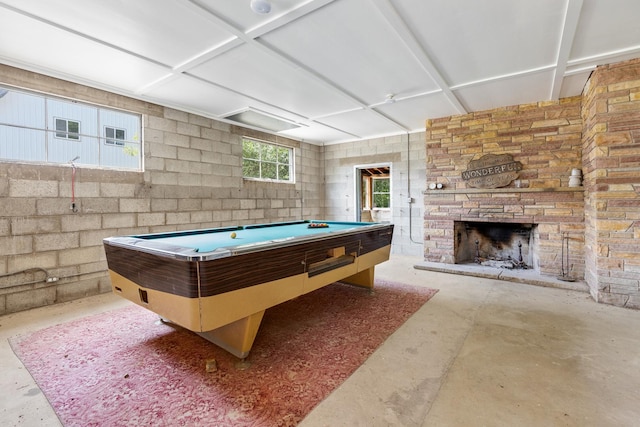 recreation room featuring a fireplace, concrete flooring, and pool table