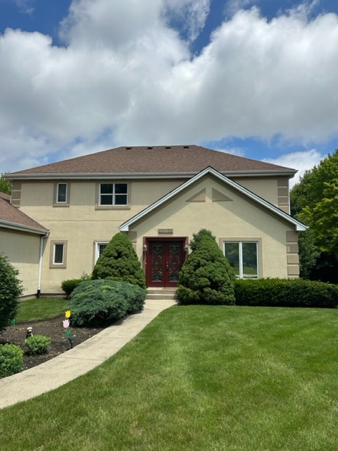 view of front of property with french doors and a front lawn