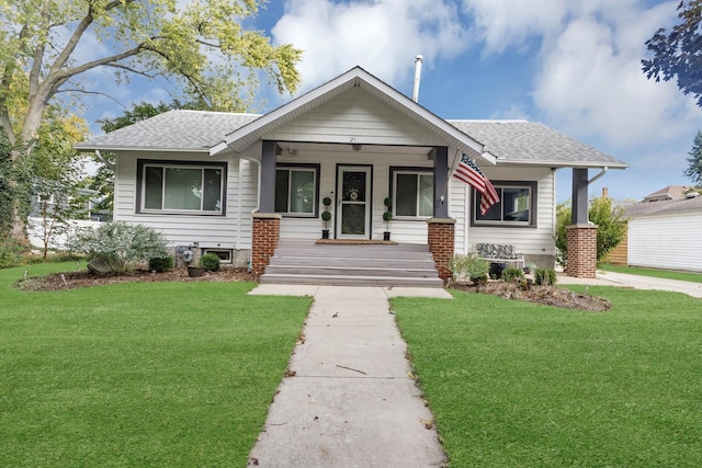 bungalow-style house with a porch and a front yard