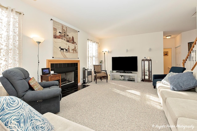 carpeted living room with a fireplace