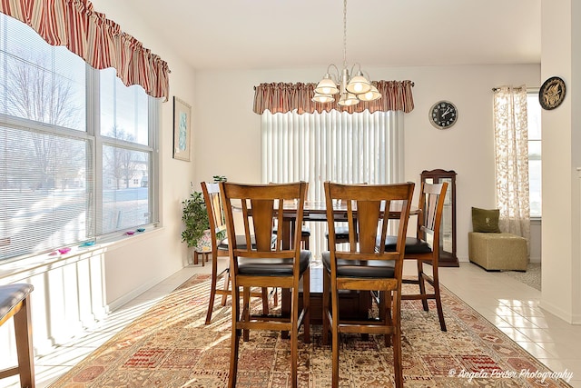 tiled dining area featuring an inviting chandelier