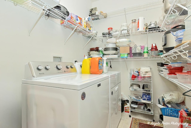 washroom featuring light tile patterned floors and washer and clothes dryer