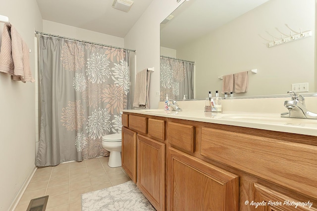 bathroom with vanity, tile patterned floors, and toilet