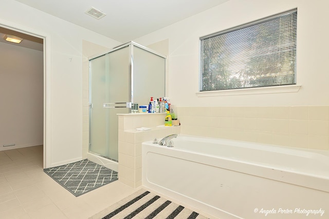 bathroom with shower with separate bathtub