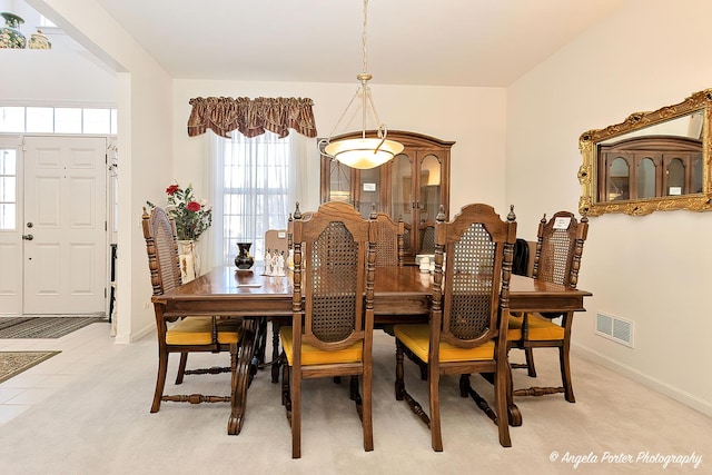 dining space featuring light tile patterned flooring