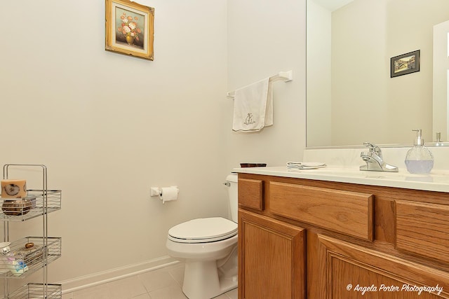 bathroom featuring vanity, tile patterned floors, and toilet