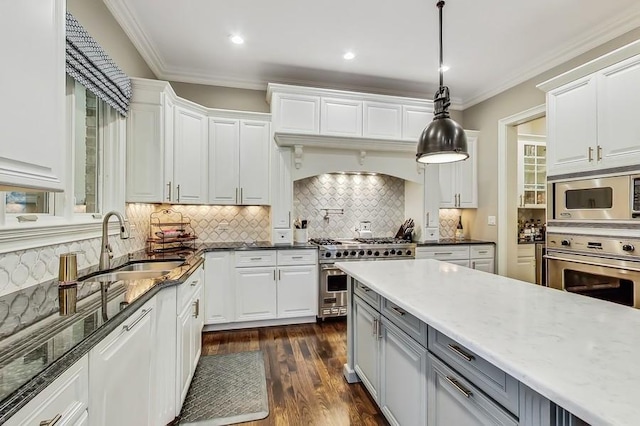 kitchen with white cabinetry, hanging light fixtures, and stainless steel appliances