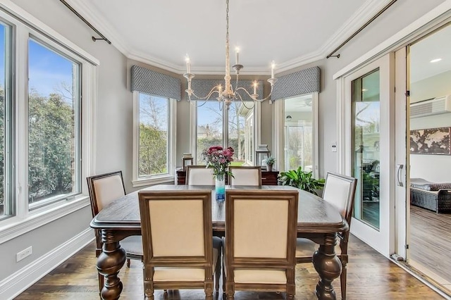 dining room with ornamental molding, dark hardwood / wood-style flooring, and a chandelier