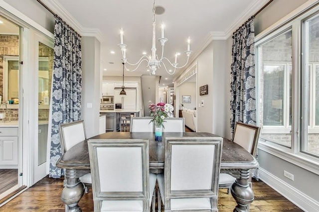 dining space featuring ornamental molding, dark wood-type flooring, and an inviting chandelier