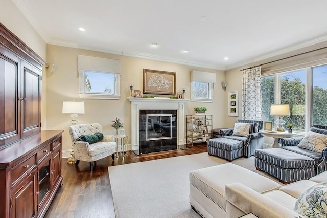 living room featuring dark wood-type flooring, ornamental molding, and a healthy amount of sunlight