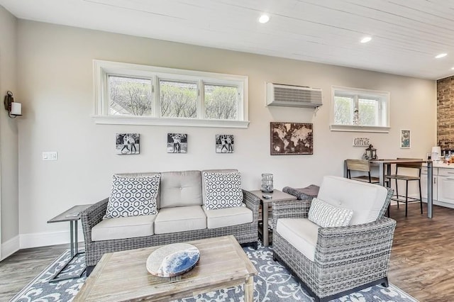 living room with dark hardwood / wood-style floors and an AC wall unit