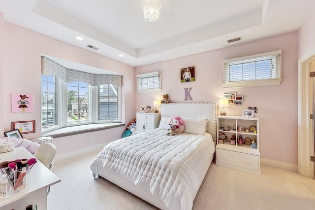 bedroom featuring a raised ceiling and carpet