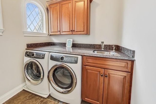 laundry room featuring cabinets, sink, and washing machine and dryer