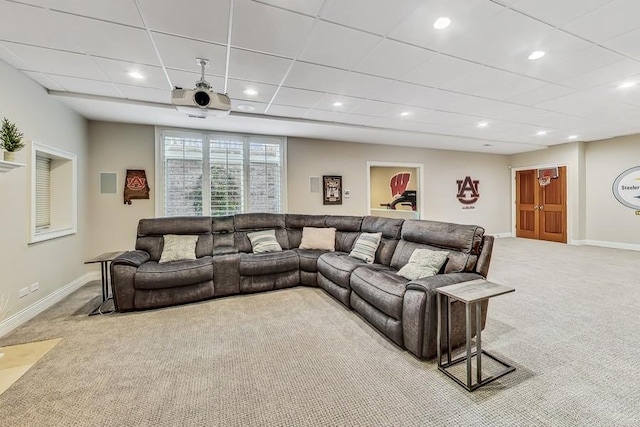 living room featuring light carpet and a paneled ceiling