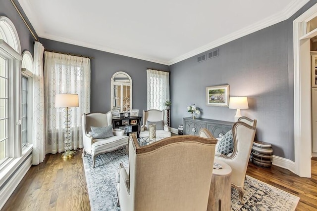 sitting room featuring ornamental molding, plenty of natural light, and light hardwood / wood-style flooring