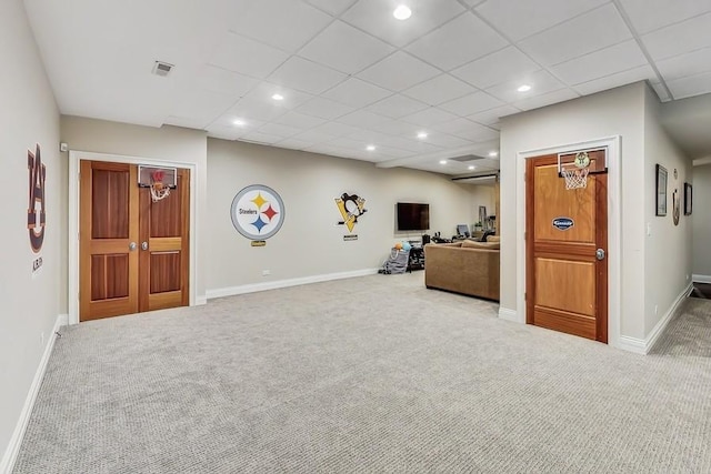 unfurnished living room featuring a paneled ceiling and carpet flooring