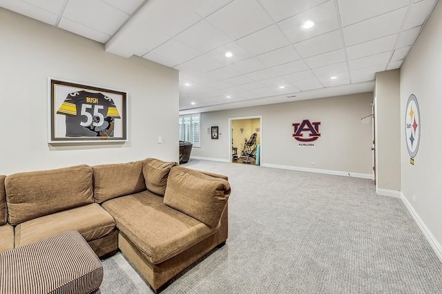 living room featuring a paneled ceiling and carpet flooring