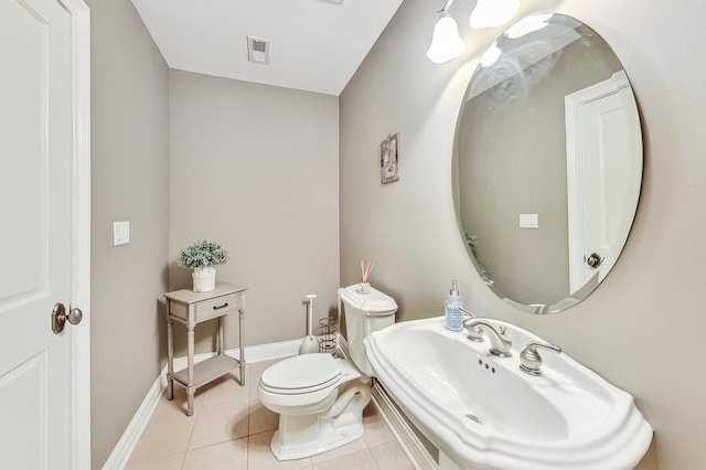 bathroom with tile patterned flooring, sink, and toilet