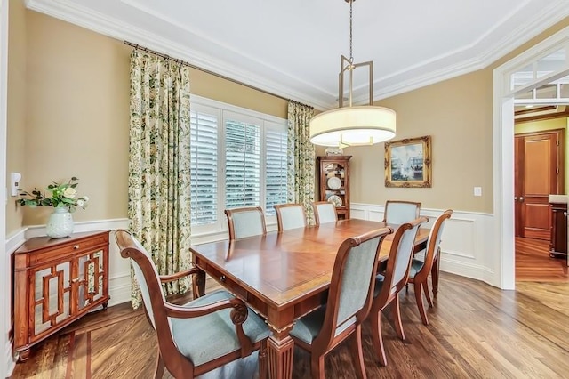 dining room with crown molding and wood-type flooring