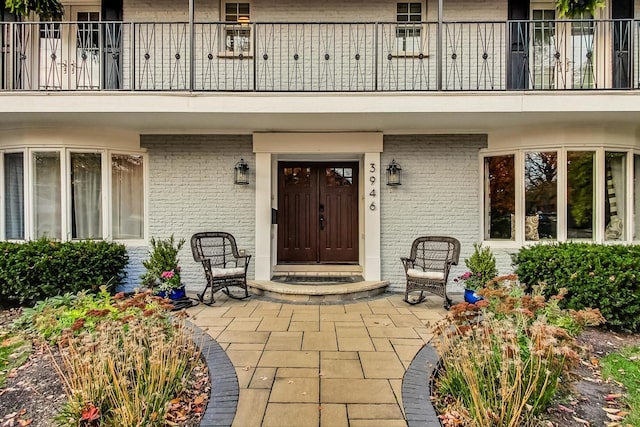 property entrance with a patio and a balcony