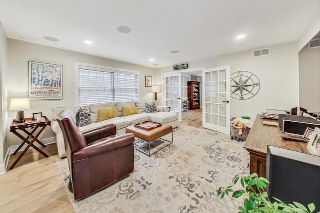 living room with french doors and light hardwood / wood-style flooring