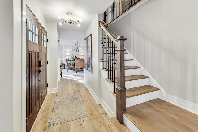 foyer featuring a chandelier and light hardwood / wood-style flooring