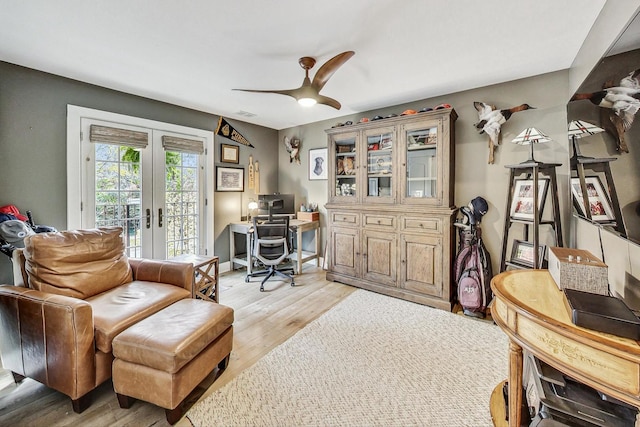 office space with ceiling fan, light hardwood / wood-style floors, and french doors