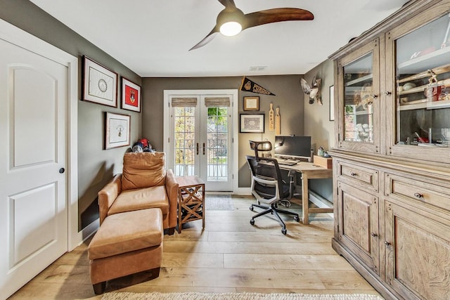 home office featuring ceiling fan, light hardwood / wood-style floors, and french doors