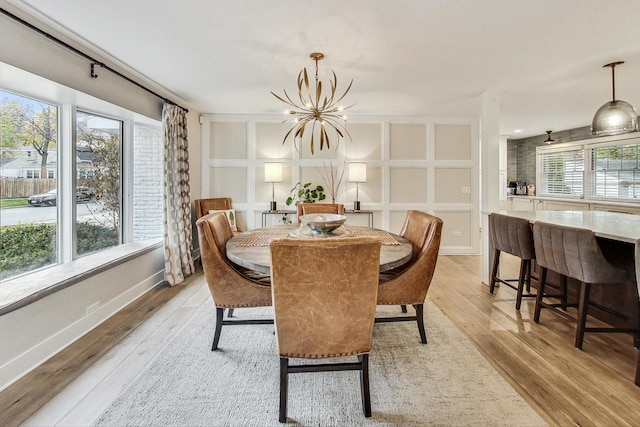 dining room with an inviting chandelier and light wood-type flooring