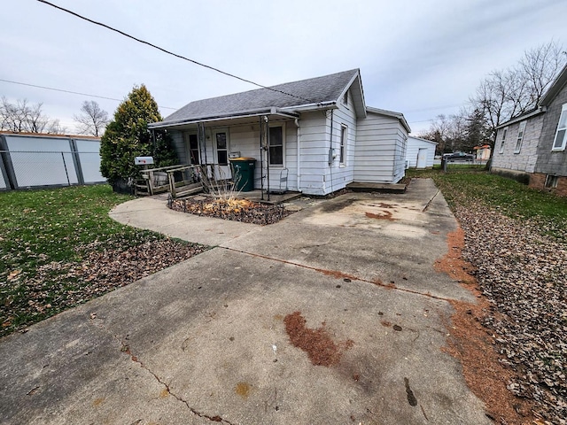 back of property featuring covered porch