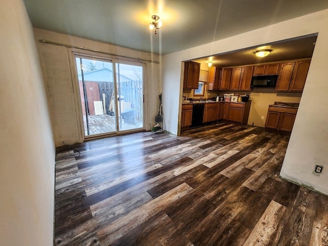 kitchen with black appliances and dark hardwood / wood-style floors