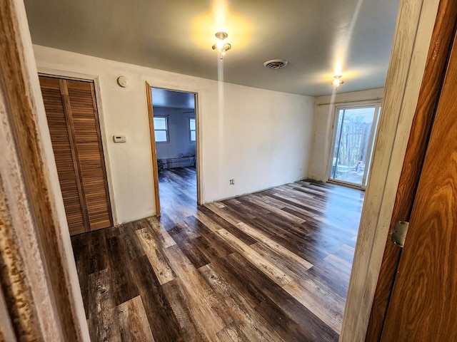 unfurnished room featuring dark hardwood / wood-style floors