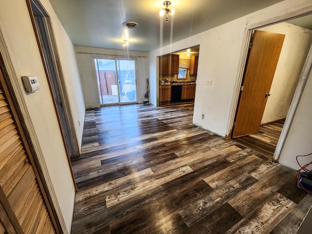 unfurnished living room featuring dark wood-type flooring