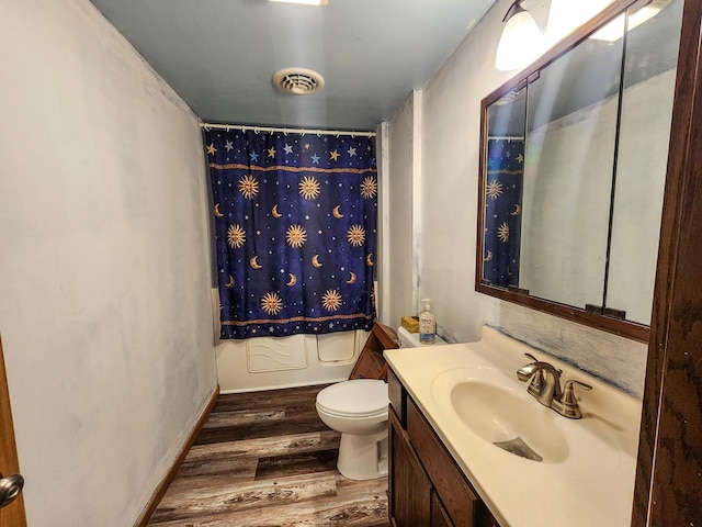 full bathroom featuring vanity, toilet, hardwood / wood-style floors, and shower / bath combo with shower curtain