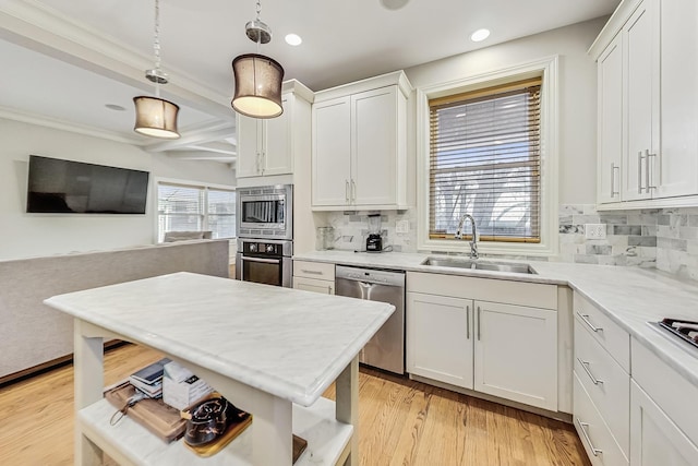 kitchen featuring sink, appliances with stainless steel finishes, hanging light fixtures, tasteful backsplash, and white cabinets