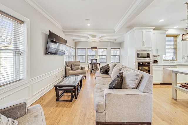 living room with sink, crown molding, coffered ceiling, light hardwood / wood-style floors, and beamed ceiling