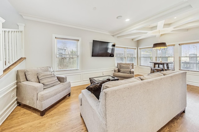 living room with crown molding, beam ceiling, coffered ceiling, and light wood-type flooring