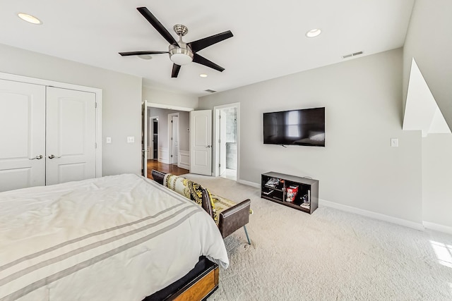 carpeted bedroom featuring a closet and ceiling fan