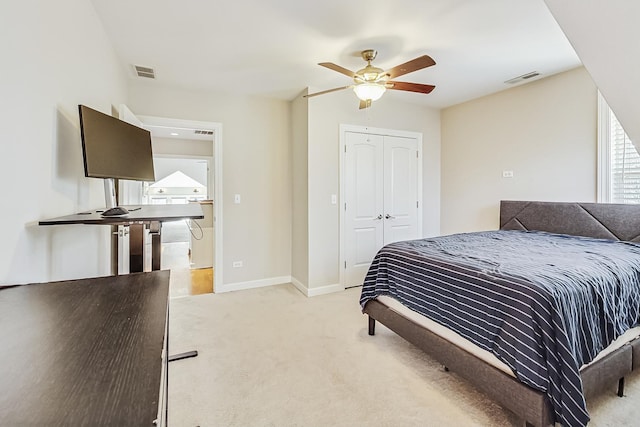 carpeted bedroom featuring a closet and ceiling fan