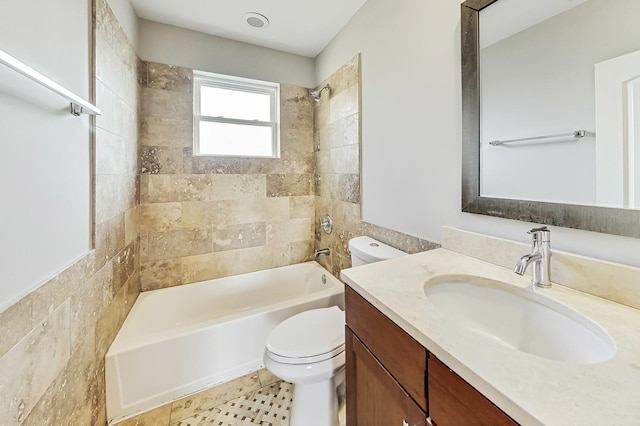 full bathroom with tiled shower / bath, vanity, tile patterned floors, and toilet