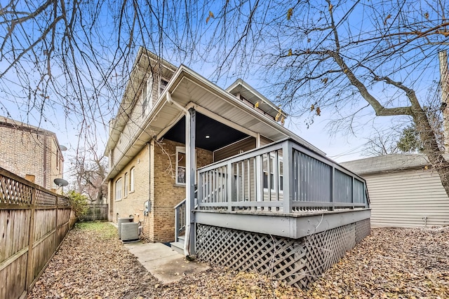 rear view of house with cooling unit and a deck